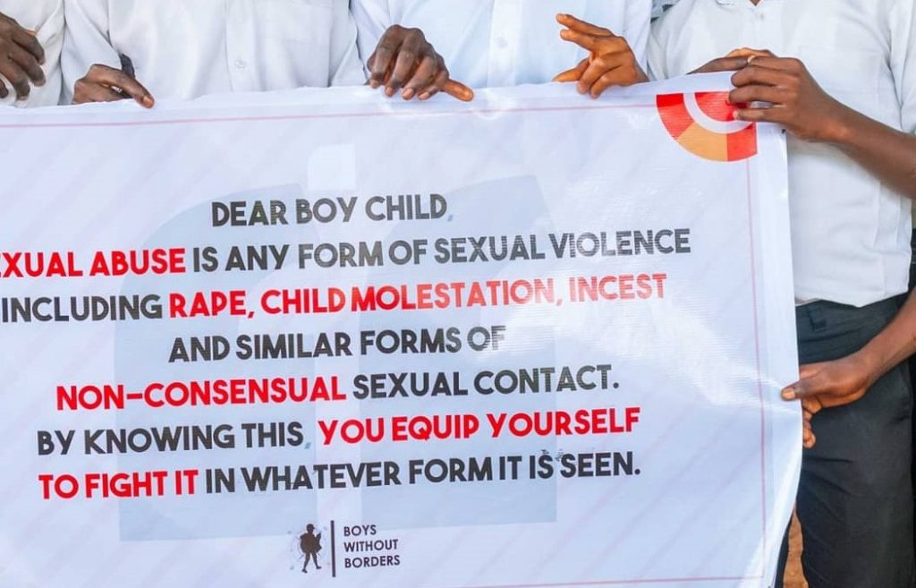 A banner talking about boy child sexual abuse
