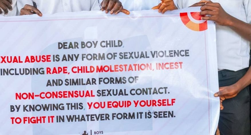 A banner talking about boy child sexual abuse
